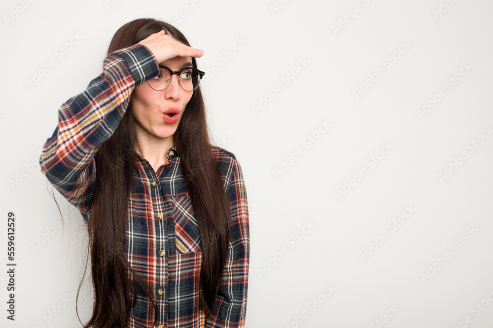 Young caucasian woman isolated on white background looking far away keeping hand on forehead. Young caucasian woman isolated on white background looking far away keeping hand on forehead.