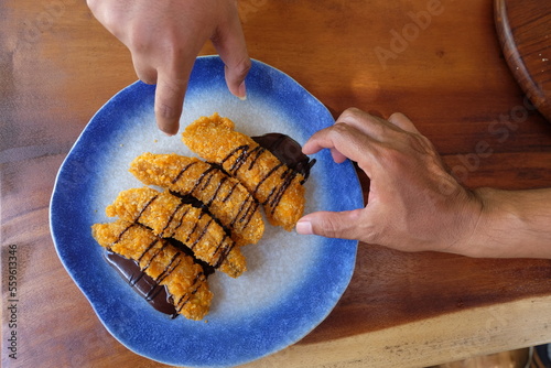 Crispy fried banana sprinkled with melted chocolate.