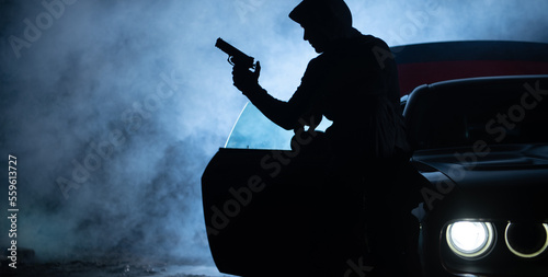 Photography Bandit with a Gun on the Streets During Foggy Dark Night