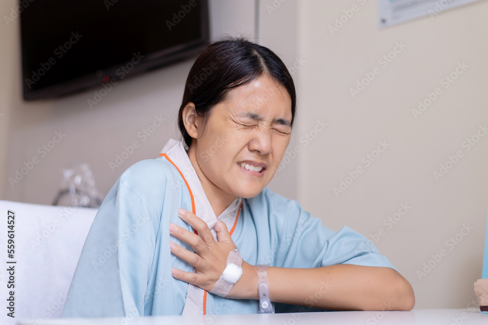Patient woman with strong chest pain and hands clutching on chest,Heart attack pectoris symptom Patient woman with strong chest pain and hands clutching on chest,Heart attack pectoris symptom