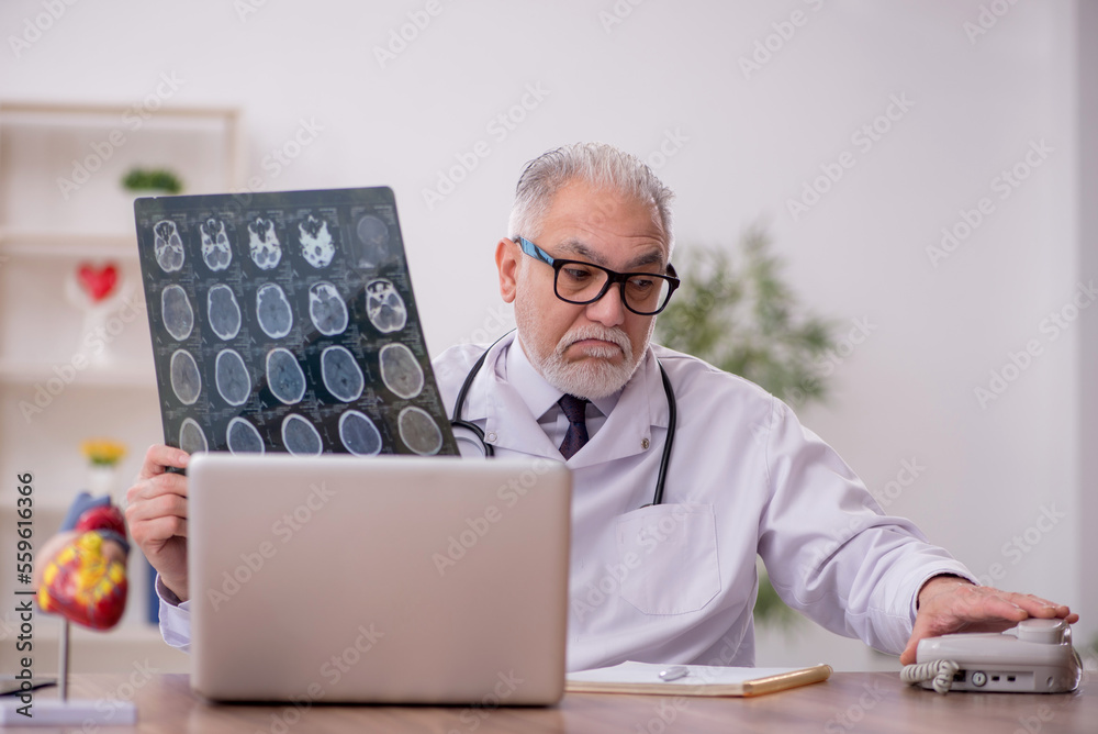 Old male doctor radiologist working in the clinic Old male doctor radiologist working in the clinic