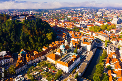 View from drone of historical center of Slovenian city of Ljubljana with medieval castle on Castle Hill in autumn morning