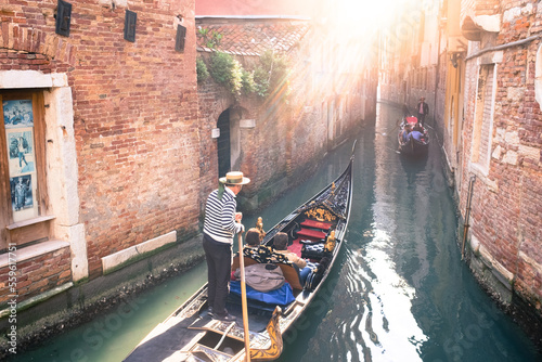 Fényképezés Gondola carrying tourists through the canals of Venice on a sunny afternoon
