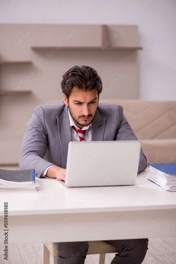 Young male employee working from home during pandemic Young male employee working from home during pandemic
