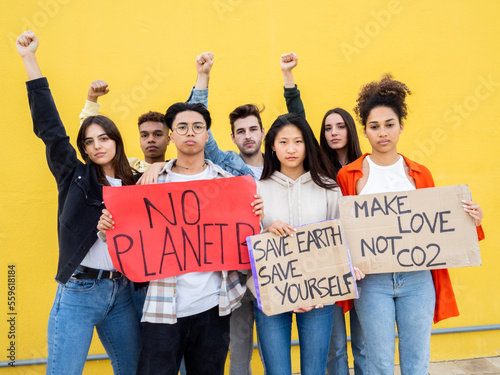 Group of young diverse teenagers protesting against climate change photo