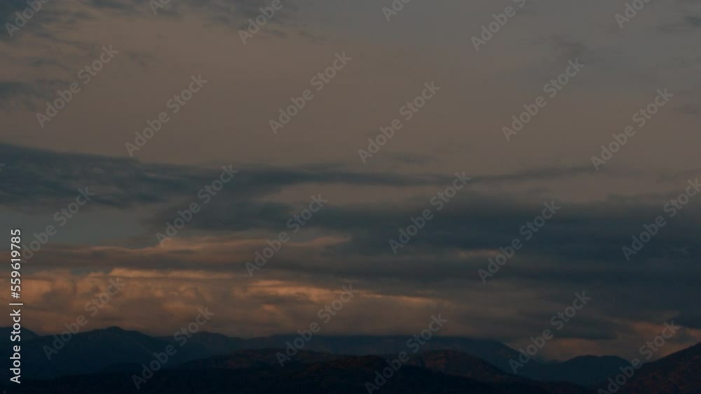 Sunset clouds over snowy peaks. Mesmerizing sky in the mountain landscape. Going black Sunset clouds over snowy peaks. Mesmerizing sky in the mountain landscape. Going black