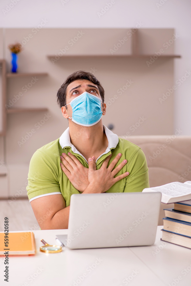 Young male student preparing for exams at home during pandemic Young male student preparing for exams at home during pandemic