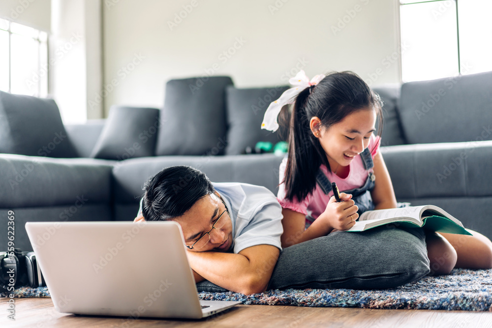 Father and asian kid little girl learn and look at laptop computer reviewing lesson study with online education e-learning.student look for educational knowledge in homeschool at home.Education