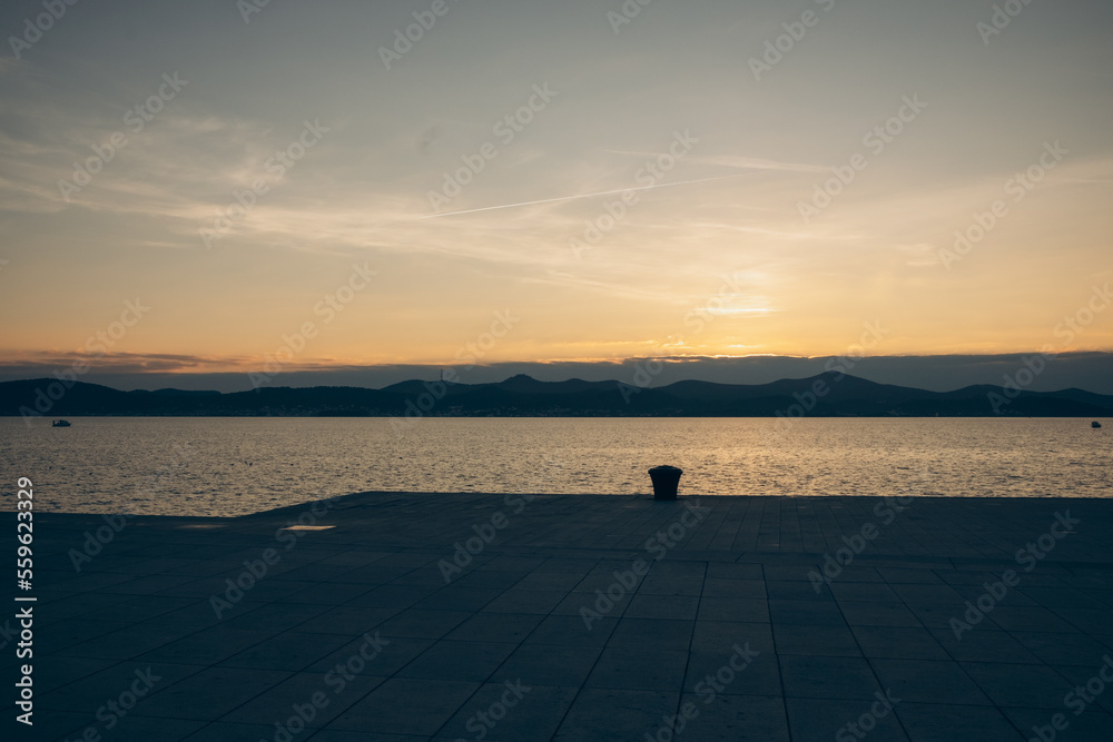 Fototapeta premium sunset over the sea on the background of the embankment