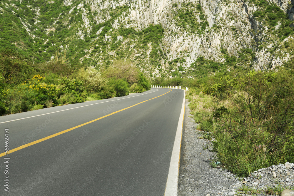 Picturesque view of big mountains and bushes near road Picturesque view of big mountains and bushes near road