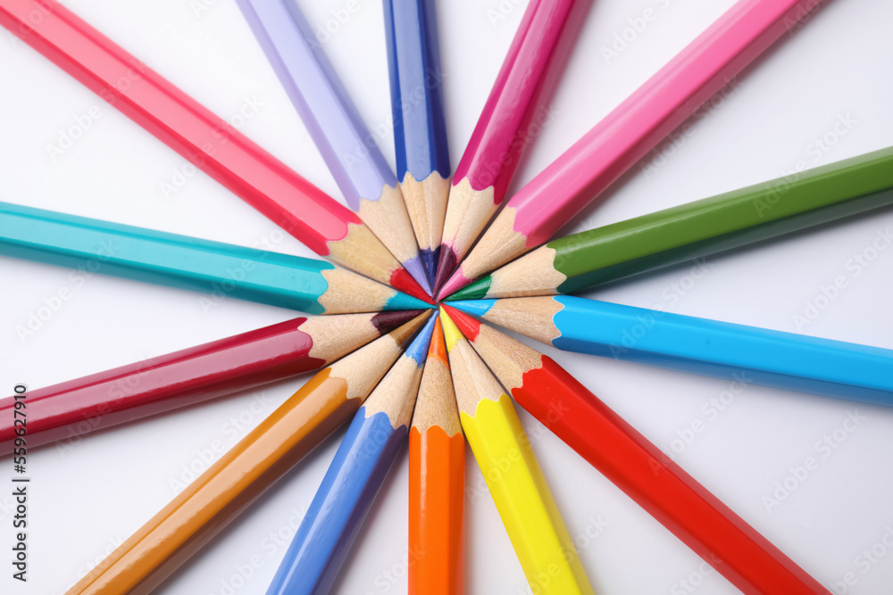 Colorful wooden pencils on white background, flat lay