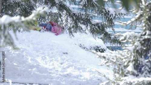 Kids sliding past in snow photo