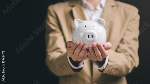 Piggy bank in the hands of a man ,finance and banking, fund growth and savings concept, saving money for the future, efficient financial planning,saving for retirement,protection of your money