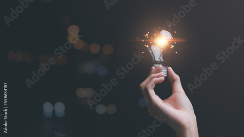 Obraz na płótnie solution concept and demonstrating leadership strategies,that lead the business in a successful direction,with innovation and brain power from brainstorming,light bulb in human hand w salonie