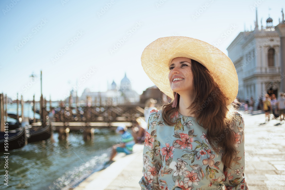 smiling elegant woman in floral dress enjoying promenade