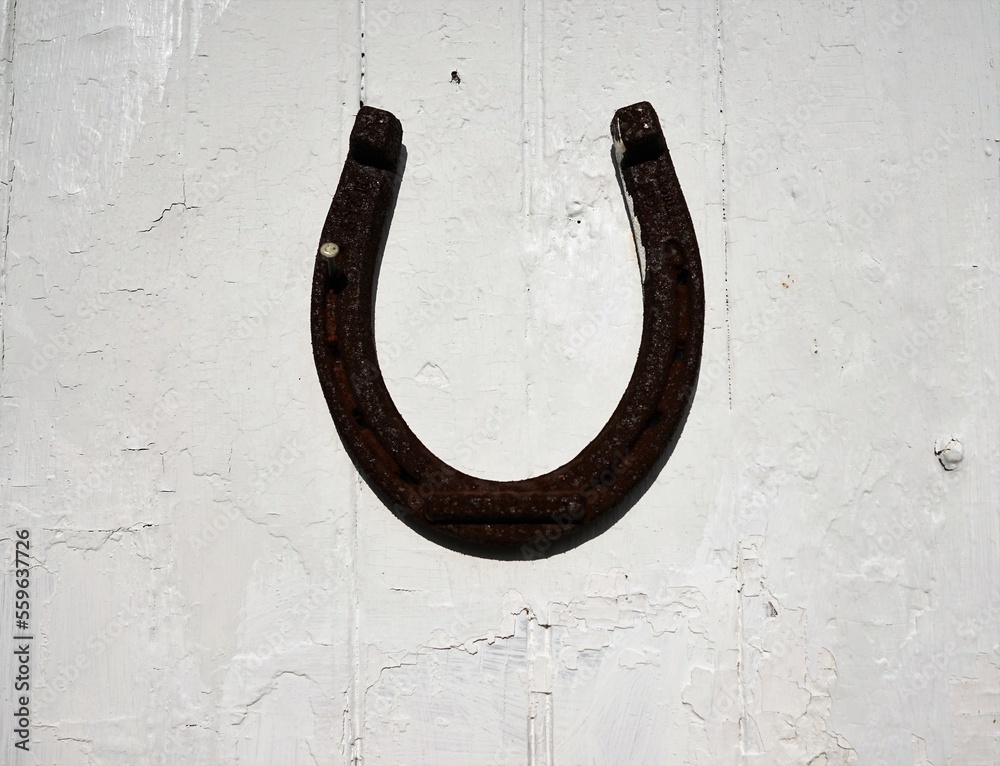 old horseshoe on wooden wall old horseshoe on wooden wall