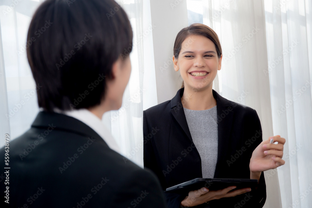 Young manager talking with secretary about report marketing on digital tablet for planning at office, executive discussion with employee woman together, leadership and employee, business concept. Young manager talking with secretary about report marketing on digital tablet for planning at office, executive discussion with employee woman together, leadership and employee, business concept.