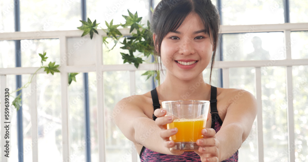 Women hands holding cold orange juice fresh fruit cool drinking. Asian women smile laugh look at camera health care home fitness lifestyle. Beautiful female pouring orange juice from cocktail bottle Women hands holding cold orange juice fresh fruit cool drinking. Asian women smile laugh look at camera health care home fitness lifestyle. Beautiful female pouring orange juice from cocktail bottle