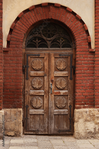 Entrance of house with beautiful arched wooden door © New Africa