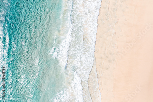 Aerial view of stunning waves crushing near sand banks in a stunning blue water