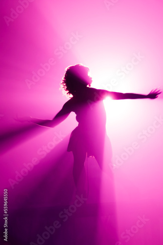 Silhouette of go go dancer in night club