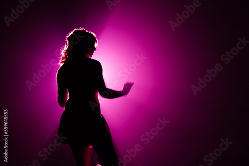 Silhouette of go go dancer in night club