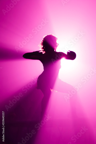 Silhouette of go go dancer in night club