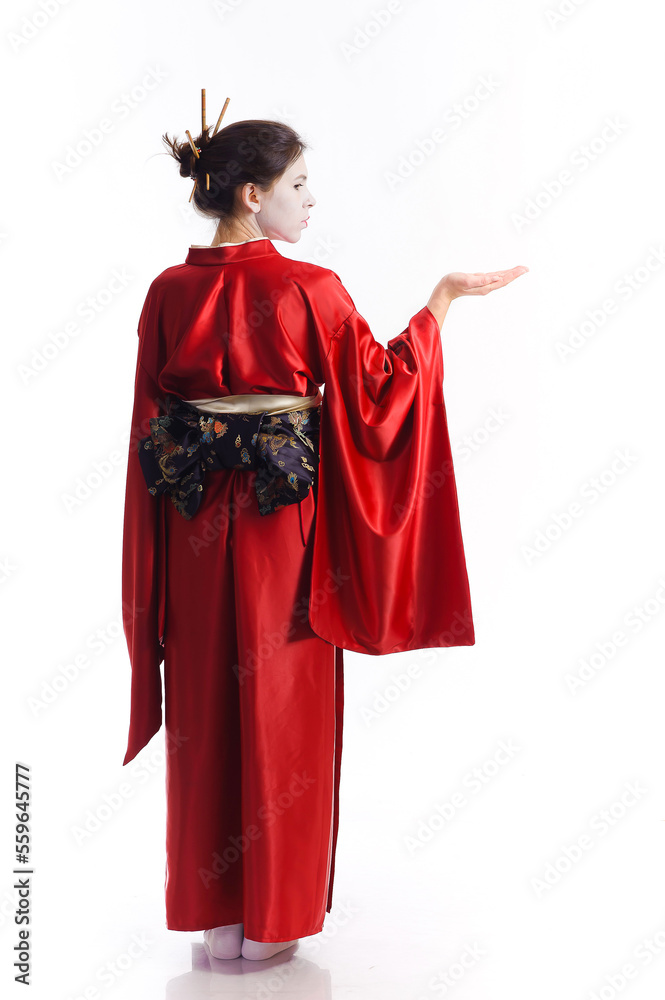 The girl in native costume of japanese geisha, isolated on white