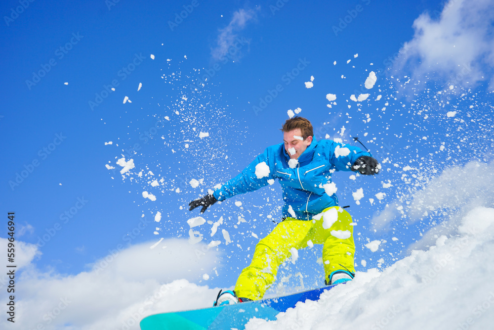 young man on the snowboard in winter