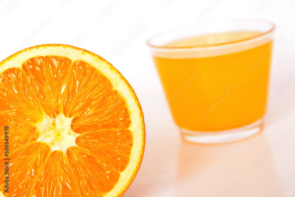 bright yellow orange pulp close up on a blurred background of a glass with natural juice. White background. Tilt horizon bright yellow orange pulp close up on a blurred background of a glass with natural juice. White background. Tilt horizon