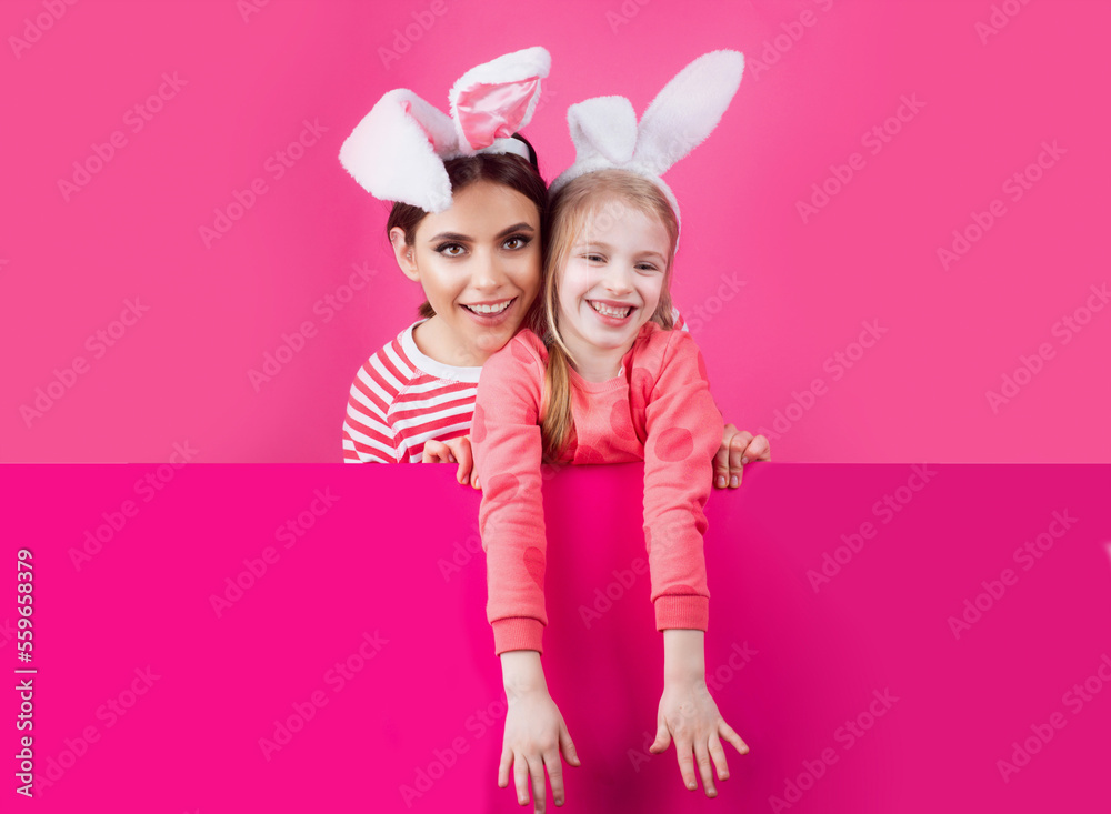 Fototapeta premium Happy childhood. Girls with bunny ears. Little sister kids celebrate easter. Egg hunt. Spring holiday.