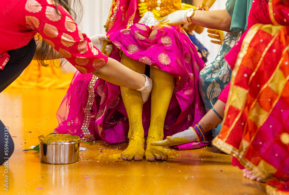 Indian Hindu pre wedding yellow turmeric Haldi ceremony bride's feet close up