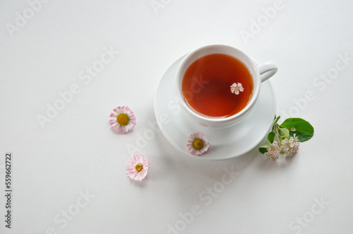 cup of tea on a light background with flowers