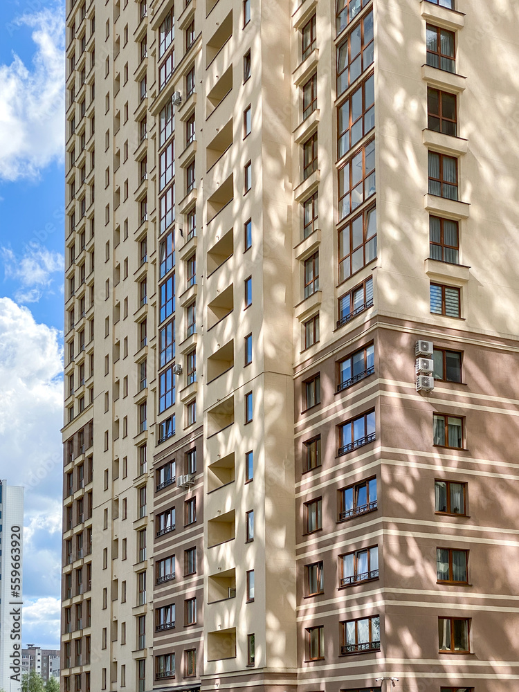 Fototapeta premium facade of high-rise residential building with sunlight reflections