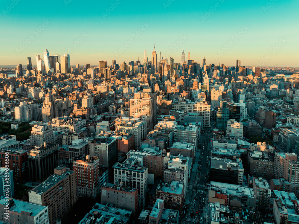 New York City skyline panorama at sunset. Manhattan building on horizon, clear sky
