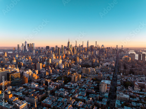 New York City skyline panorama at sunrise. Midtown Manhattan building on horizon  clear sky  copy space
