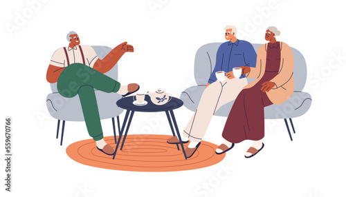 Senior friends talking, relaxing at home. Happy old people drinking tea, spea...