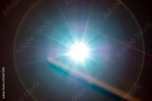 LED Flash or Flashlight of a Smartphone on black background