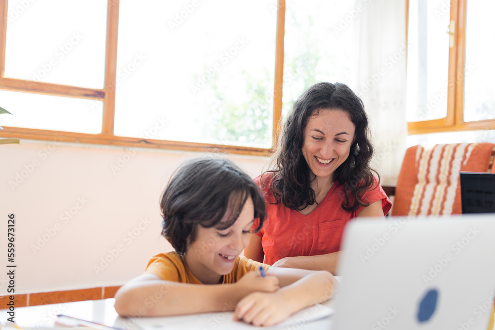 Mother and son do their homework online. distance learning online education. Home education.Schoolboy with laptop and doing homework at school.