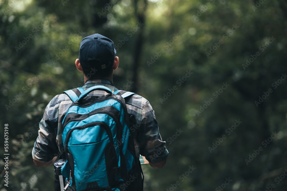 Hikers read map with backpacks on the road in the forest. hiking and adventure concept. Hikers read map with backpacks on the road in the forest. hiking and adventure concept.