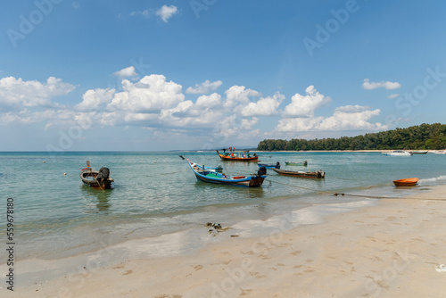 Traditional Thai longtail boats moored off the coastline, province, Thailand photo