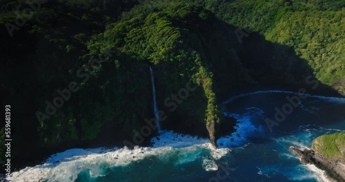 Aerial view of Maui Hawaii tropical waterfall ocean coastline 