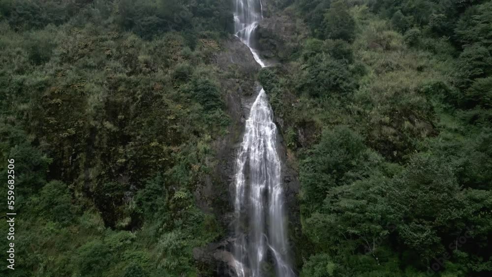 Stunning waterfall in the green lush mountains of Asia Stunning waterfall in the green lush mountains of Asia
