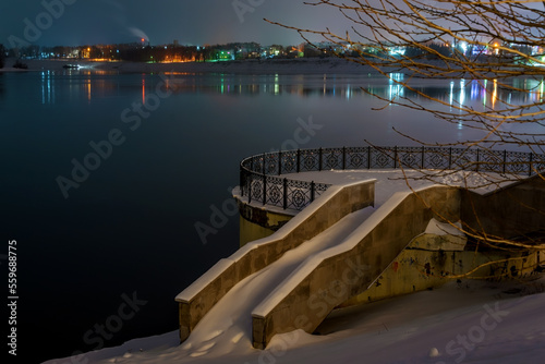 Fototapeta Naklejka Na Ścianę i Meble -  Granite stairs and terrace over the river under snow in winter.