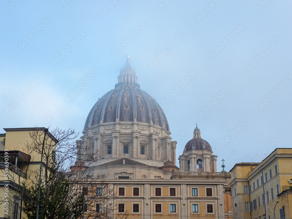 Dome of the church, basilica in the mist. Buildings, tenements, windows, shutters, blue sky.