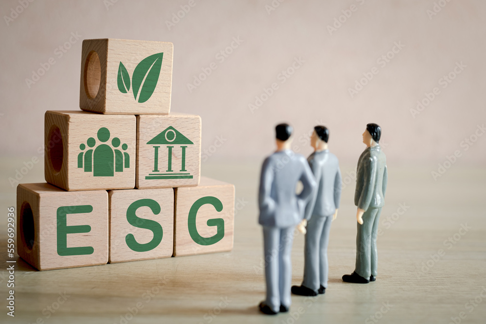 ESG ,environmental, social, and corporate governance concept.,A group of business man focus on wooden cubes with ESG word and icon showcasing a commitment to ethical and sustainable business. ESG ,environmental, social, and corporate governance concept.,A group of business man focus on wooden cubes with ESG word and icon showcasing a commitment to ethical and sustainable business.