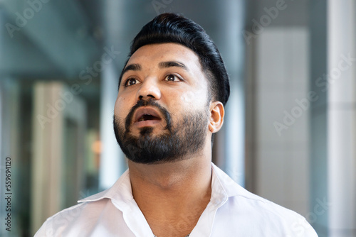 Indian office worker man or business man getting surprised and confused