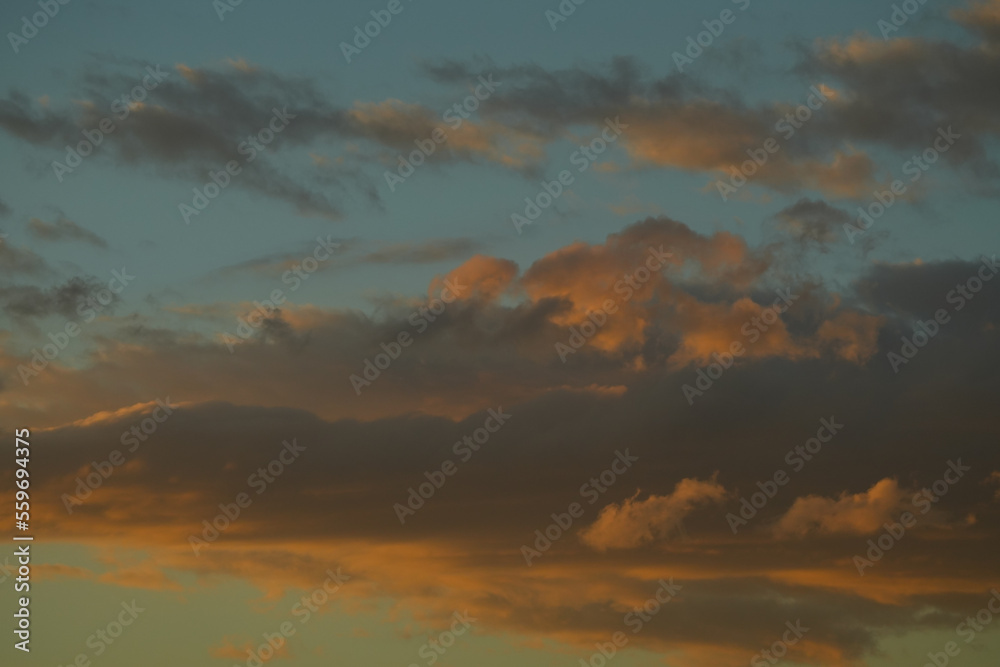 Sky with clouds at sunset. Sunset sky clouds. Cloudy sky at sunset. Beautiful sunset sky clouds.