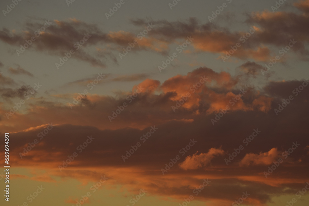 Sky with clouds at sunset. Sunset sky clouds. Cloudy sky at sunset. Beautiful sunset sky clouds.
