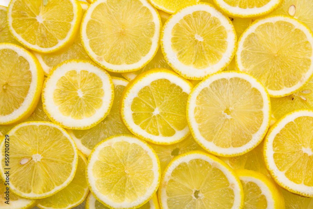 Bright lemon background. Lemon slices full frame.